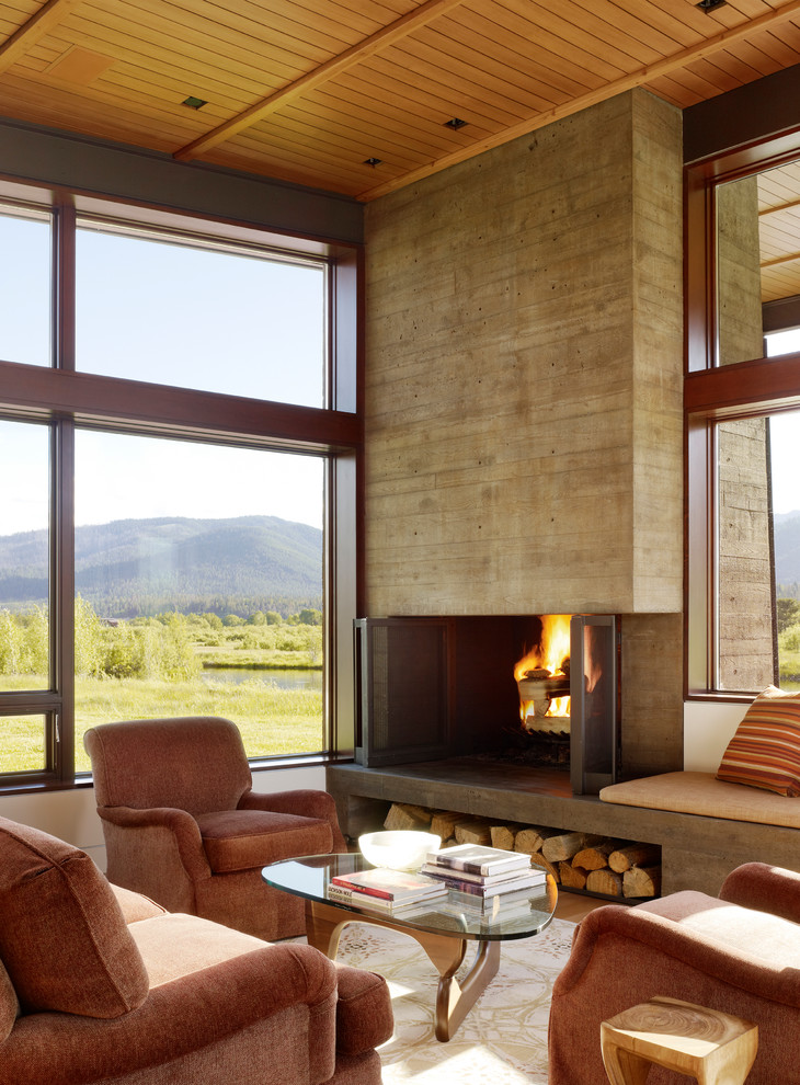 Источник вдохновения для домашнего уюта: гостиная комната в стиле модернизм с фасадом камина из бетона и коричневым диваном