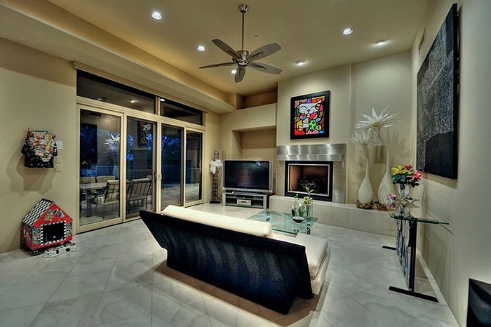 Inspiration for a huge transitional open concept travertine floor living room remodel in Phoenix with a music area, beige walls, a standard fireplace, a metal fireplace and a tv stand