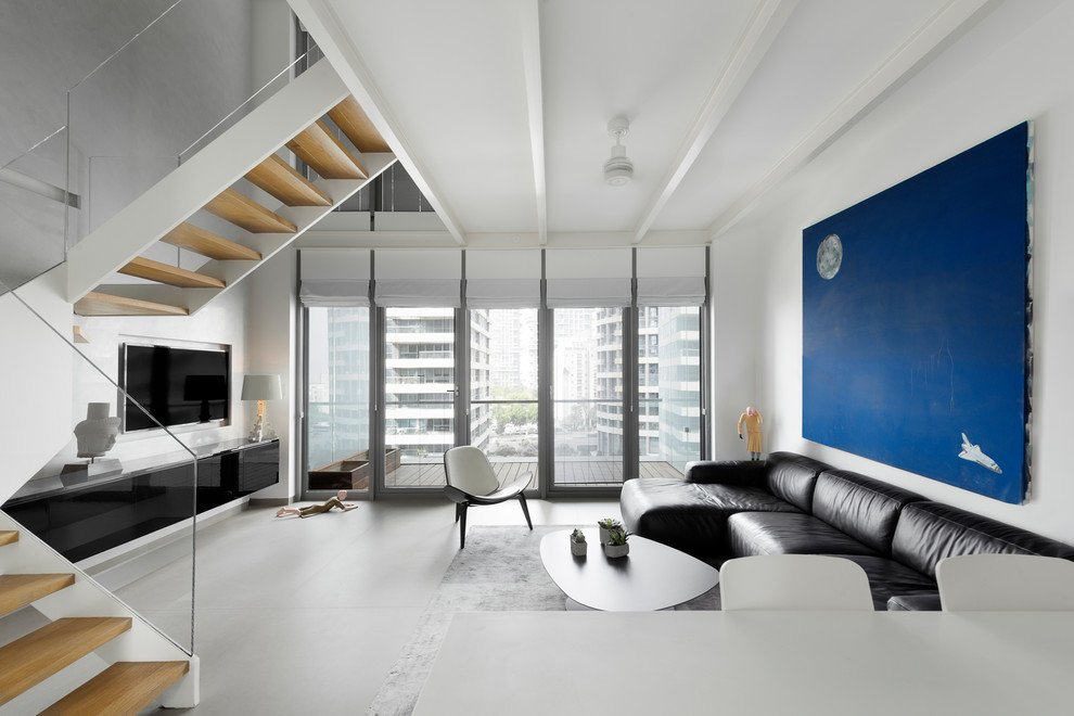 Living room - modern gray floor living room idea in New York with white walls, no fireplace and a media wall