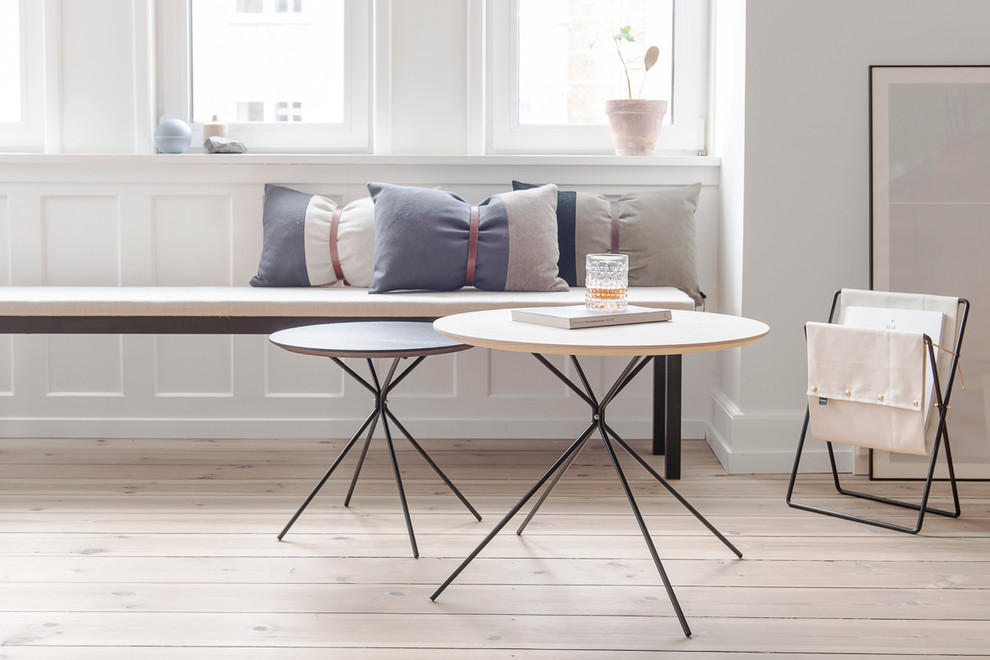 This is an example of a scandinavian living room in Copenhagen with light hardwood flooring.