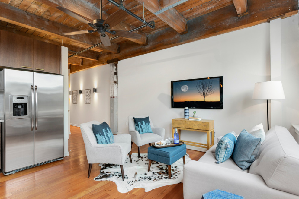 Mid-sized urban medium tone wood floor, brown floor and wood ceiling living room photo in Seattle with white walls and a wall-mounted tv