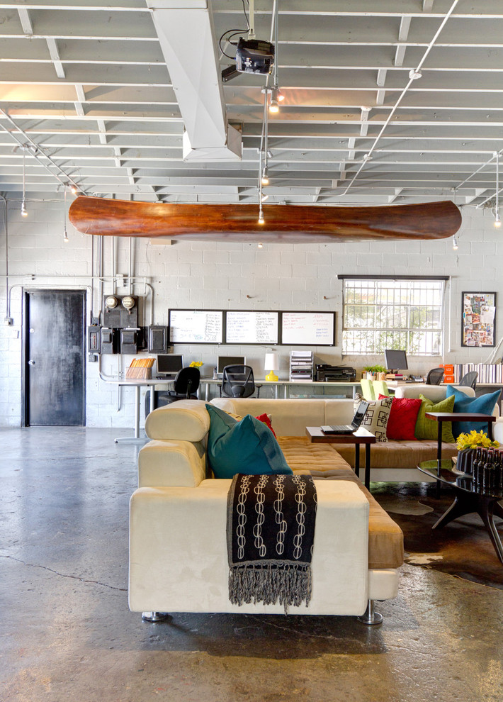 Inspiration for an industrial living room in Los Angeles with concrete flooring.