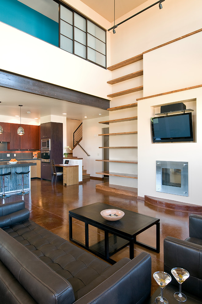 Photo of an urban open plan living room in Denver with concrete flooring and a built-in media unit.