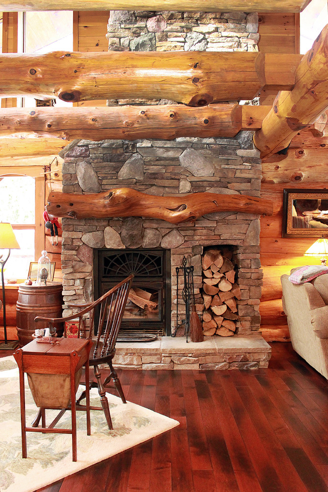 Large mountain style open concept dark wood floor living room photo in Toronto with a wood stove and a stone fireplace