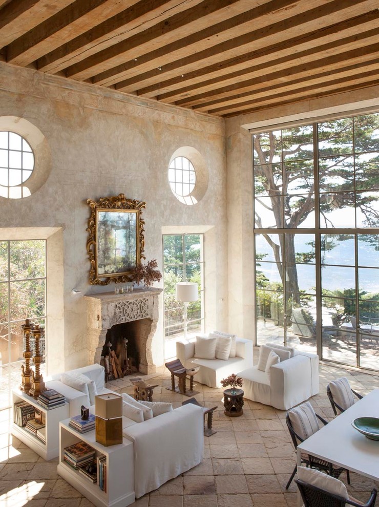Inspiration for a large mediterranean formal open plan living room in Los Angeles with beige walls, limestone flooring, a standard fireplace, a stone fireplace surround and no tv.