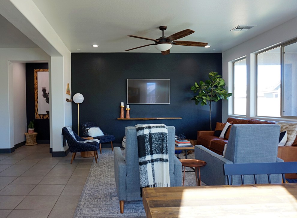 Medium sized midcentury formal open plan living room in Phoenix with black walls, porcelain flooring, no fireplace, a wall mounted tv and grey floors.