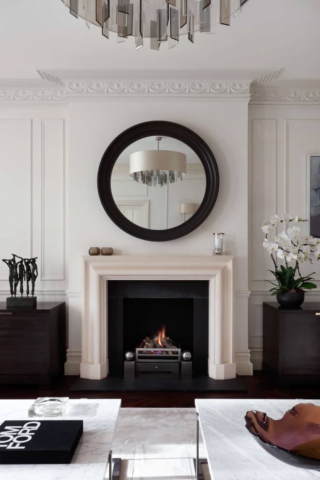 This is an example of a large contemporary open plan living room in London with white walls, dark hardwood flooring, a standard fireplace, a stone fireplace surround, a corner tv, brown floors, a coffered ceiling and wainscoting.