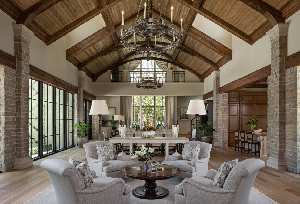 Design ideas for an open plan living room in Miami with white walls, medium hardwood flooring, brown floors, exposed beams, a vaulted ceiling and a wood ceiling.