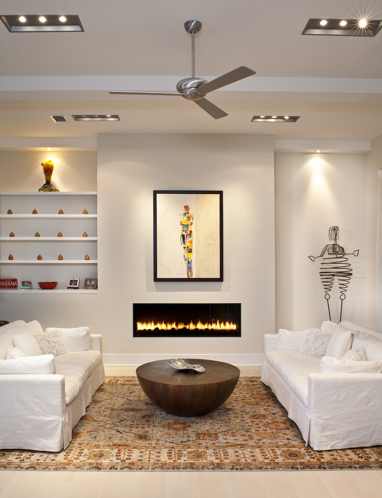 Living room - contemporary living room idea in Tampa with beige walls and a ribbon fireplace