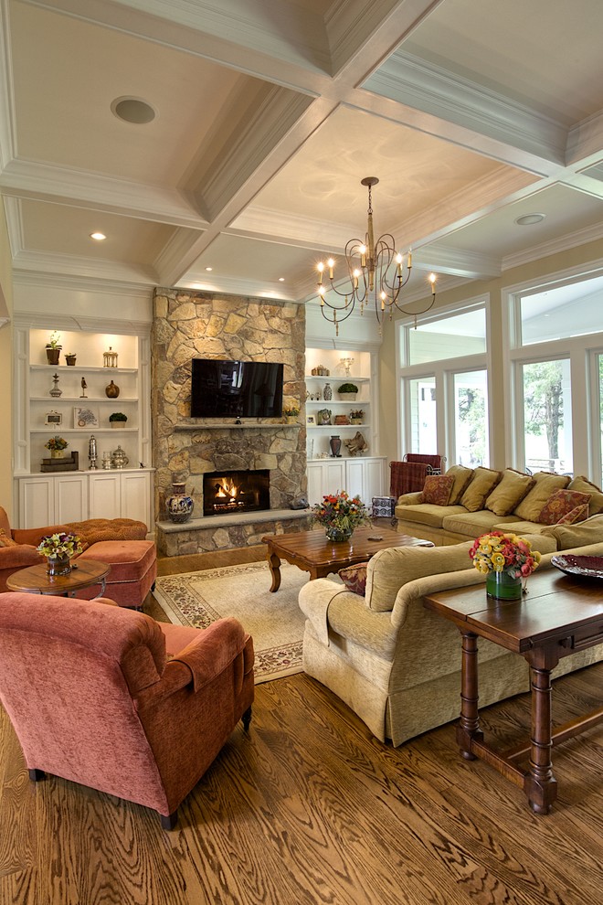 Large traditional formal open plan living room in DC Metro with a stone fireplace surround, a wall mounted tv, a ribbon fireplace, beige walls, medium hardwood flooring and brown floors.