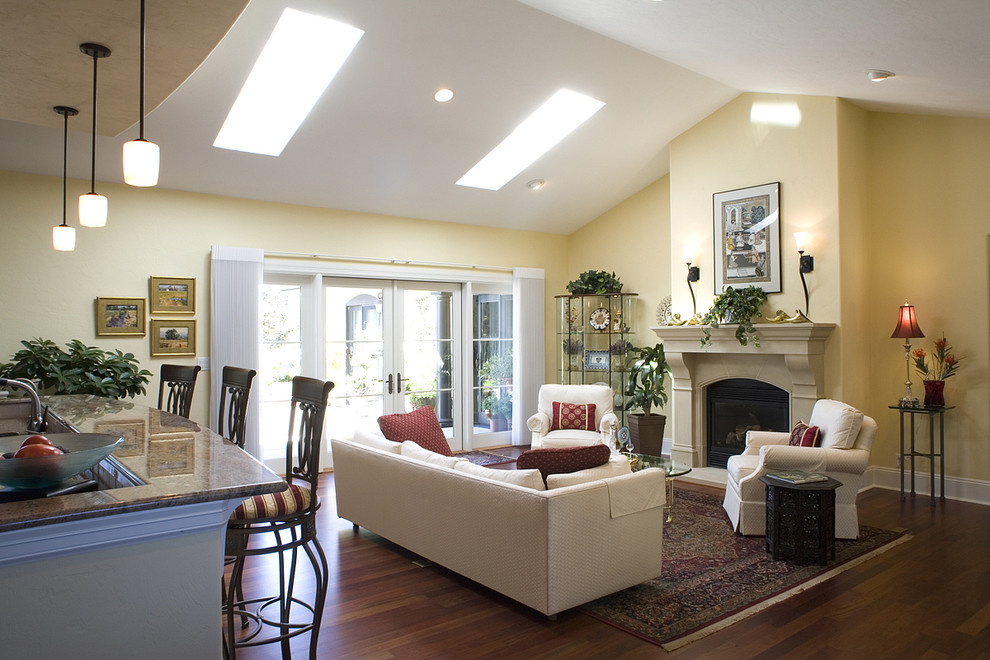 Tuscan open concept living room photo in Seattle with a standard fireplace