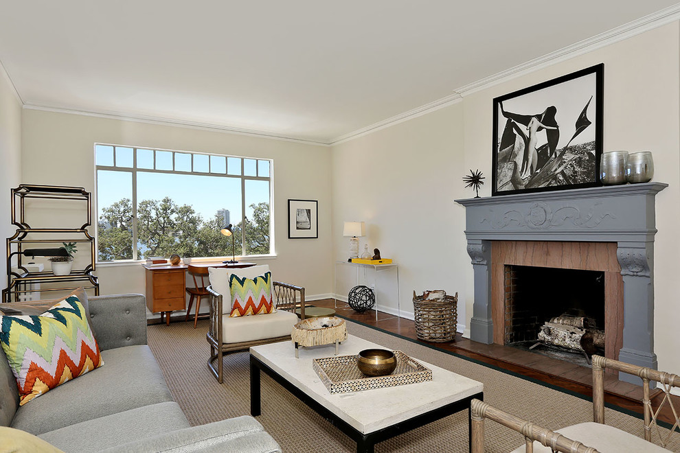Design ideas for a classic living room in San Francisco with yellow walls, dark hardwood flooring and a standard fireplace.