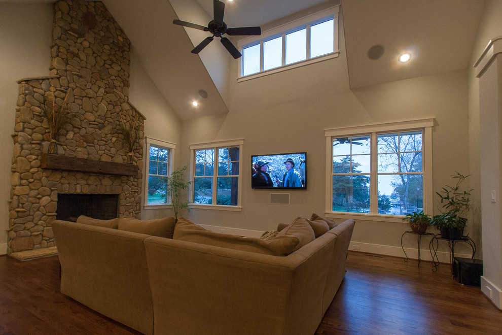 Large elegant open concept dark wood floor living room photo in Charlotte with a standard fireplace and a stone fireplace