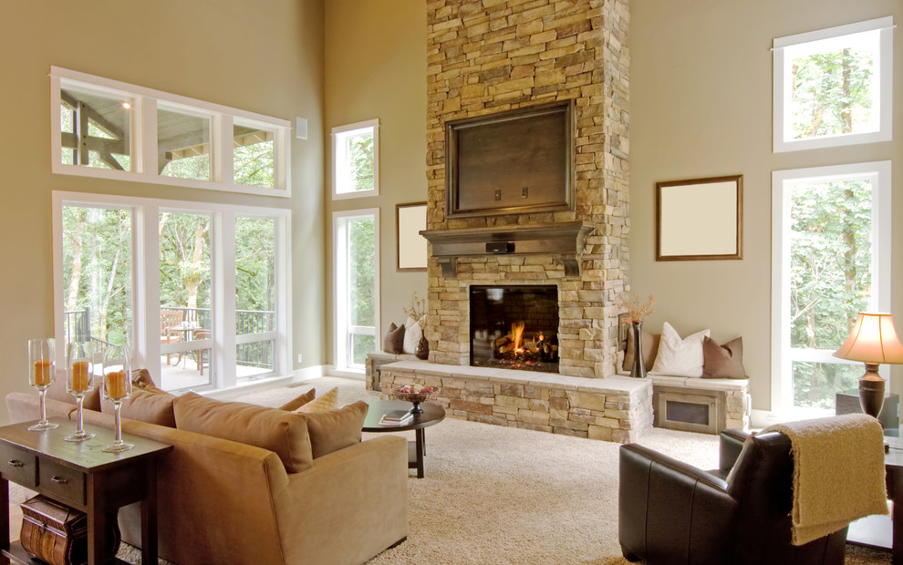 Inspiration for a large transitional open concept carpeted and beige floor living room remodel in Charlotte with beige walls, a standard fireplace, a stone fireplace and a wall-mounted tv