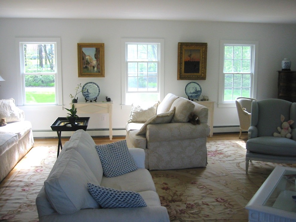 Living room - mid-sized eclectic open concept medium tone wood floor living room idea in Boston with white walls