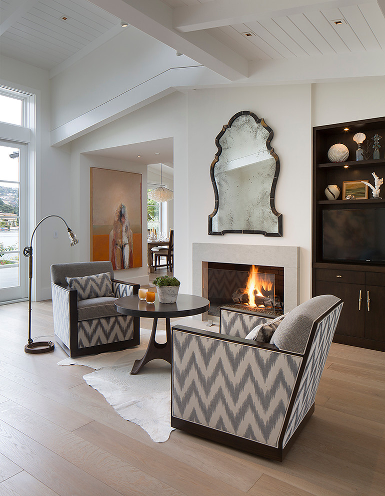 Photo of a classic living room in San Francisco with white walls, light hardwood flooring and a standard fireplace.