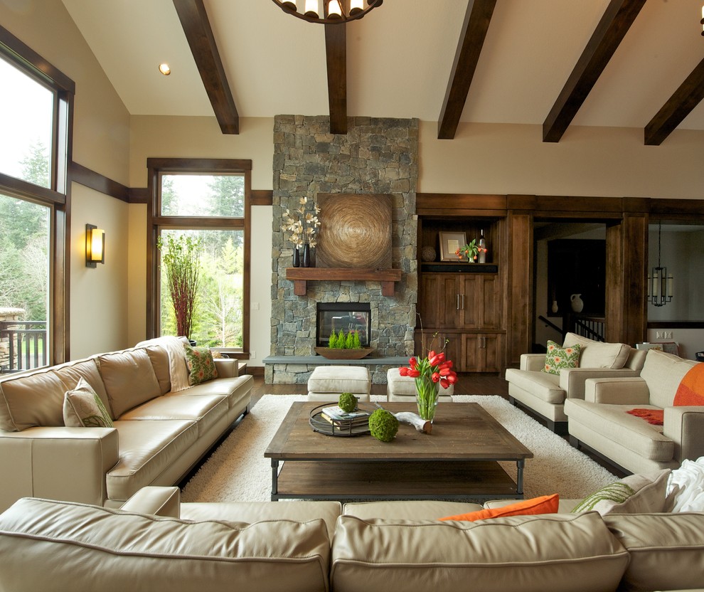 This is an example of an industrial living room in Portland with beige walls, a standard fireplace and a stone fireplace surround.