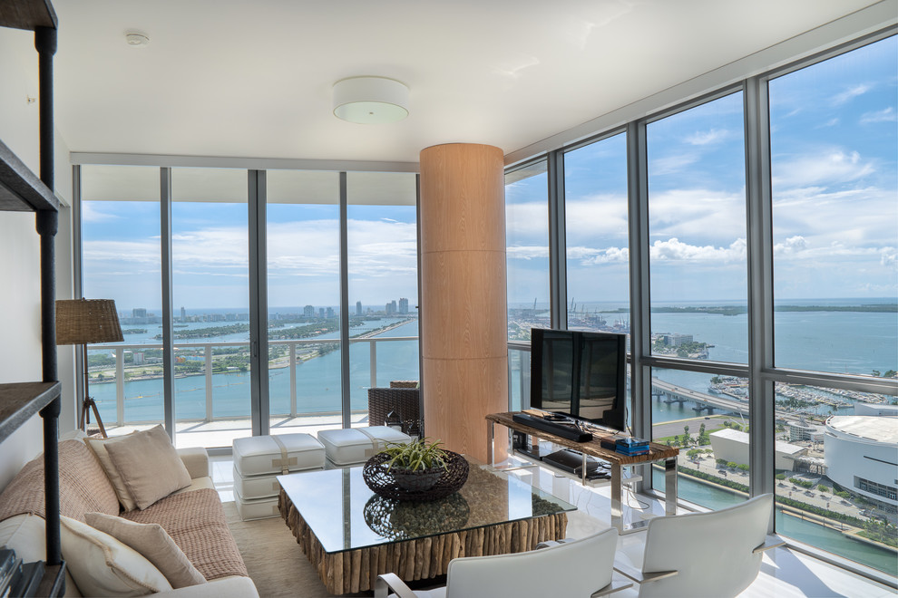 This is an example of a contemporary living room in Miami with a freestanding tv.