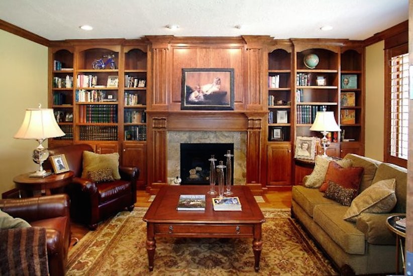 Mid-sized enclosed medium tone wood floor living room library photo in Salt Lake City with beige walls, a standard fireplace and a stone fireplace