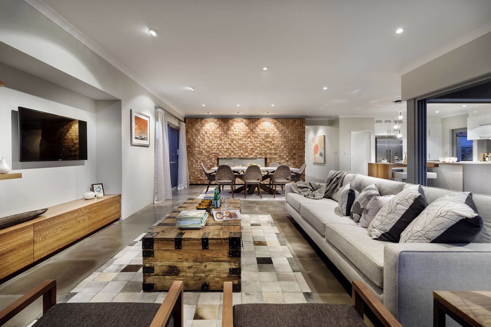 Источник вдохновения для домашнего уюта: открытая гостиная комната в современном стиле с серыми стенами и телевизором на стене