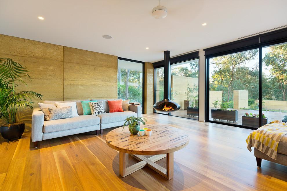Inspiration for a contemporary formal open plan living room in Melbourne with a hanging fireplace and no tv.