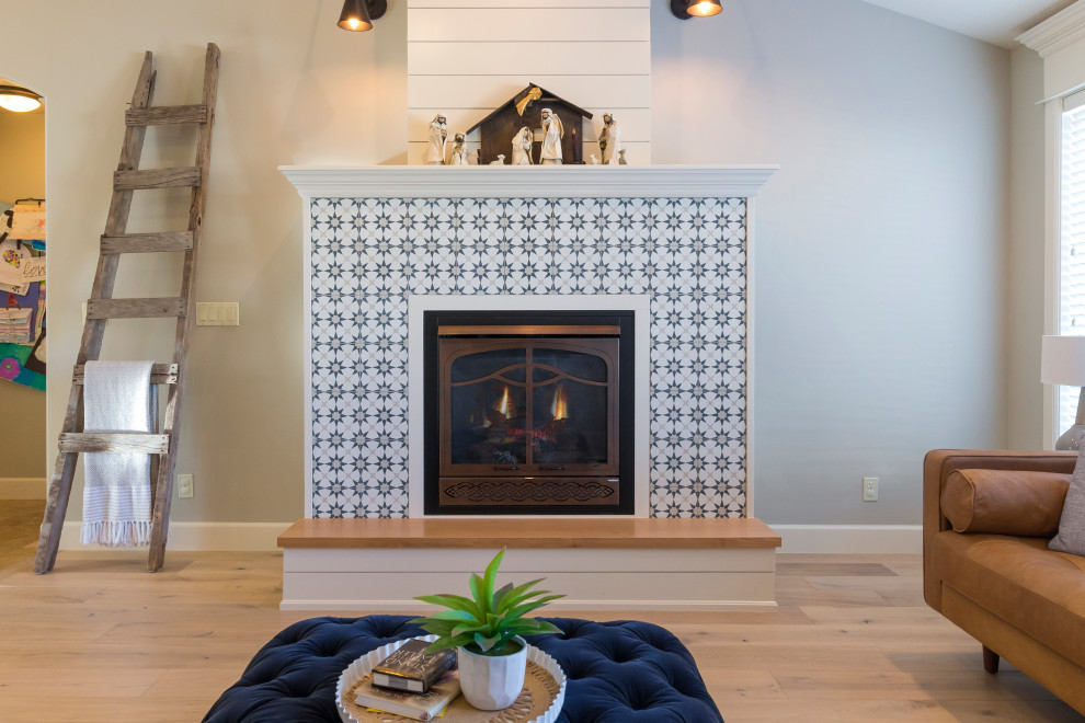 Repräsentatives, Fernseherloses Landhaus Wohnzimmer mit grauer Wandfarbe, Sperrholzboden, Kamin, gefliester Kaminumrandung und beigem Boden in Boise