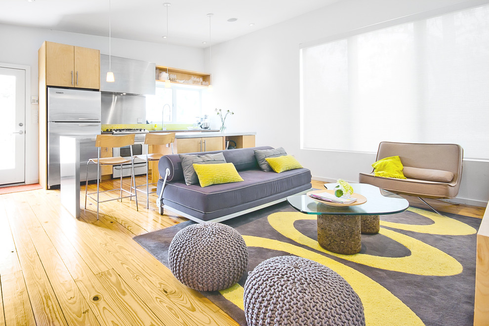 Photo of a modern grey and yellow open plan living room in Houston.