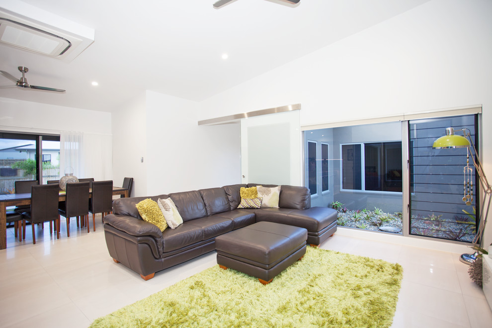 Photo of a medium sized contemporary open plan living room in Other with white walls, a wall mounted tv, ceramic flooring and white floors.