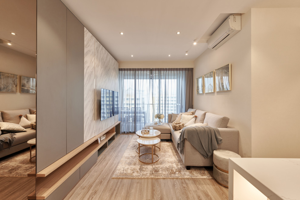 Medium sized contemporary open plan living room in Singapore with beige walls, a wall mounted tv and beige floors.