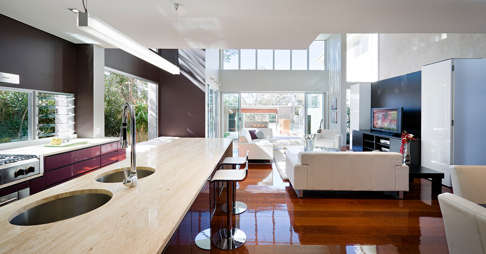 Imagen de salón abierto contemporáneo sin chimenea con paredes marrones, suelo de madera en tonos medios y pared multimedia