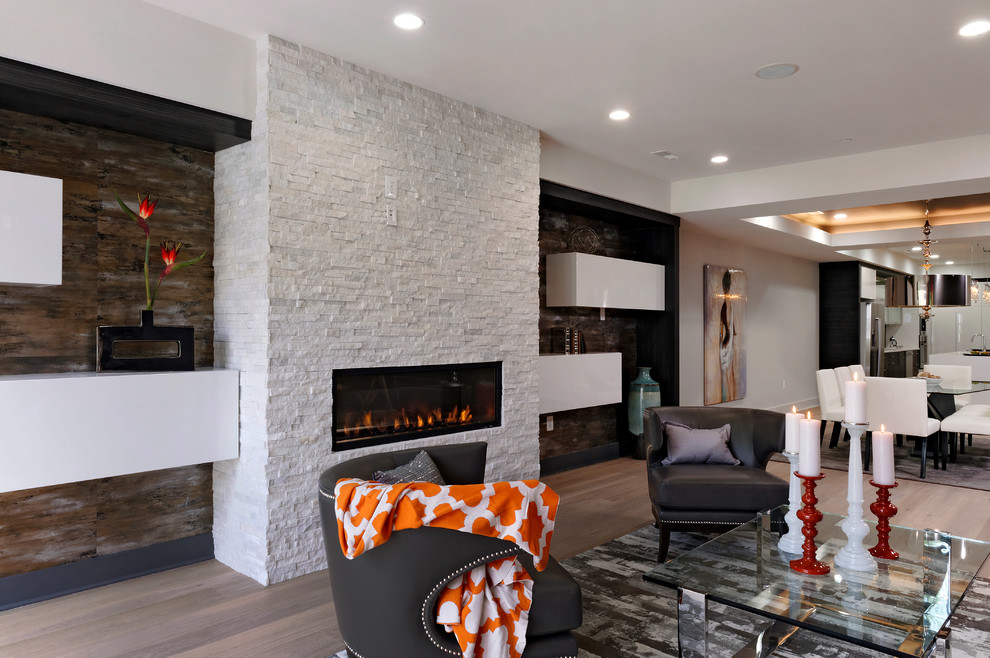 Photo of a medium sized contemporary formal open plan living room in DC Metro with grey walls, light hardwood flooring, a standard fireplace and a stone fireplace surround.