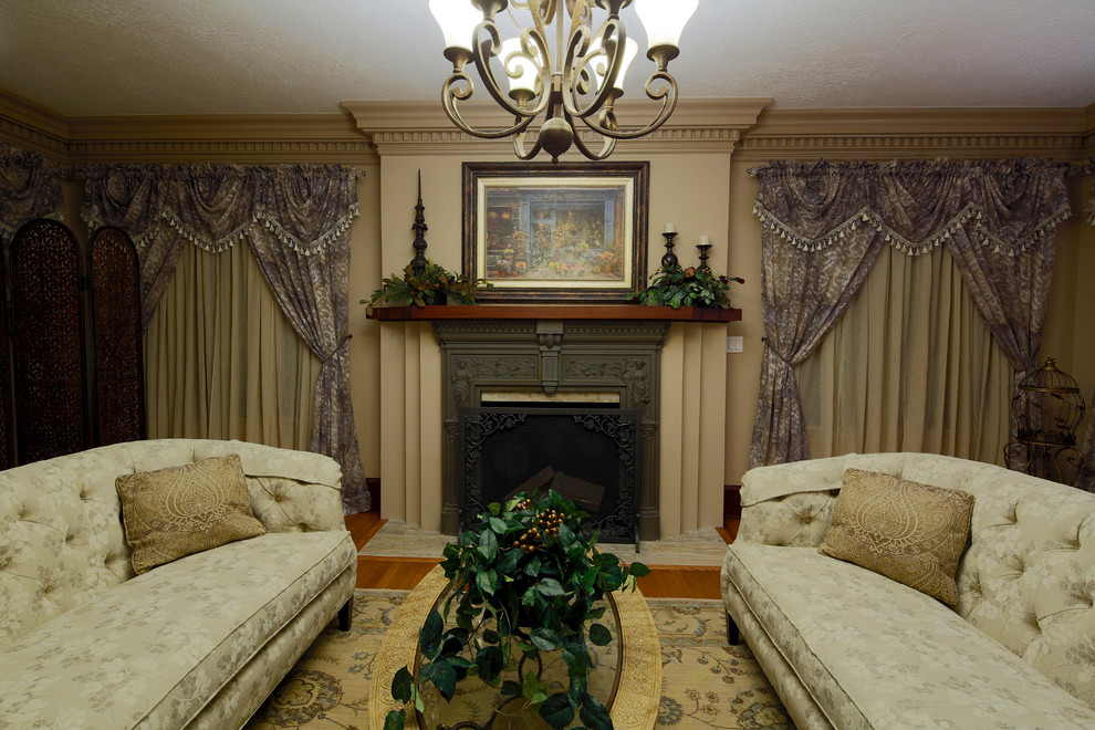 Photo of a large traditional formal enclosed living room in Charleston with medium hardwood flooring, a standard fireplace and a metal fireplace surround.