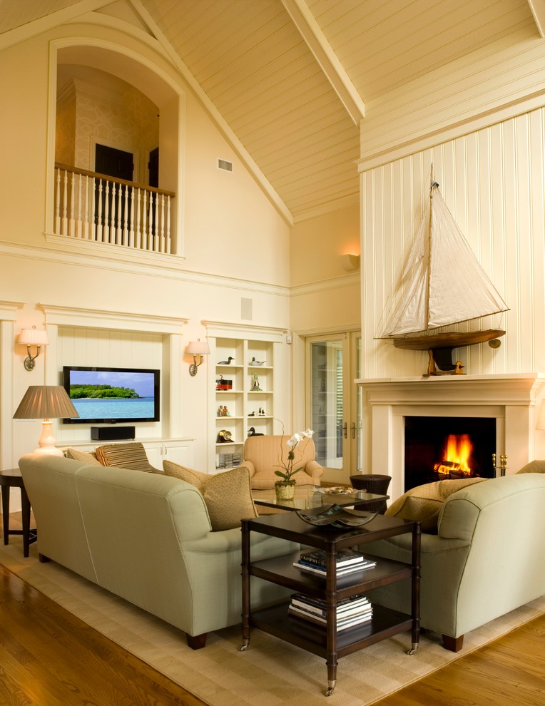 Foto di un soggiorno aperto con pareti bianche, pavimento in legno massello medio, camino classico e cornice del camino in legno