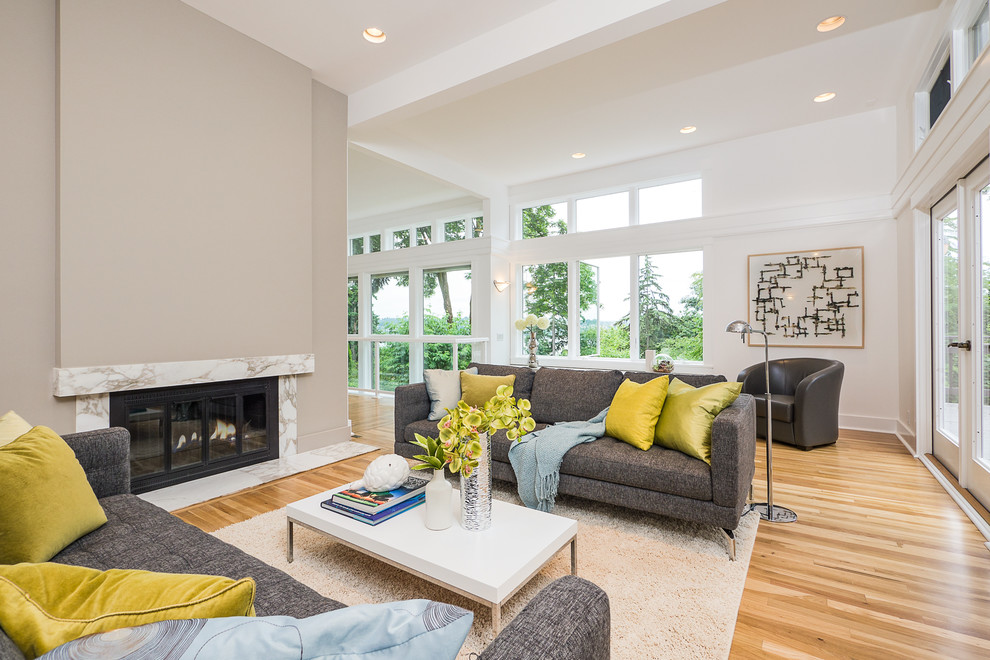 Photo of a contemporary living room in Seattle with grey walls and a standard fireplace.