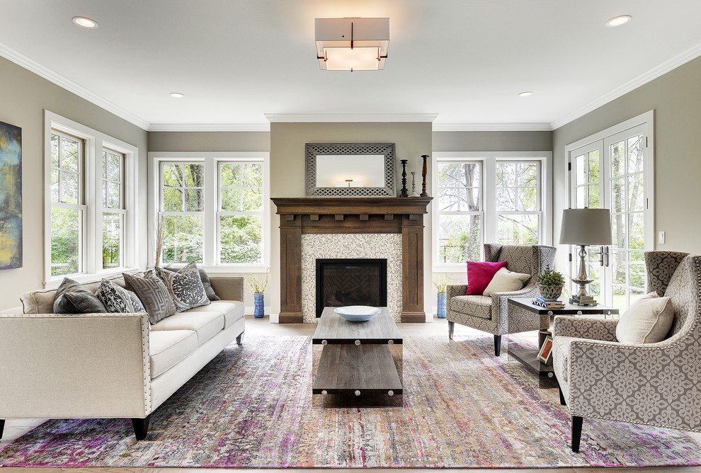 Photo of a classic formal living room in Minneapolis with grey walls, a standard fireplace and a tiled fireplace surround.