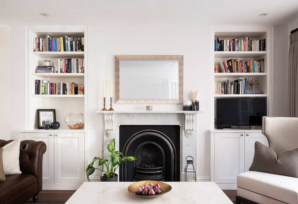 Mittelgroßes, Offenes Klassisches Wohnzimmer mit weißer Wandfarbe, dunklem Holzboden, Kamin, braunem Boden, Kaminumrandung aus Stein und freistehendem TV in London
