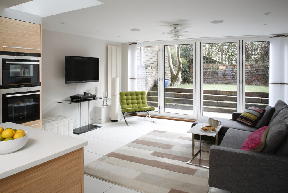 Contemporary open plan living room in London with a wall mounted tv.