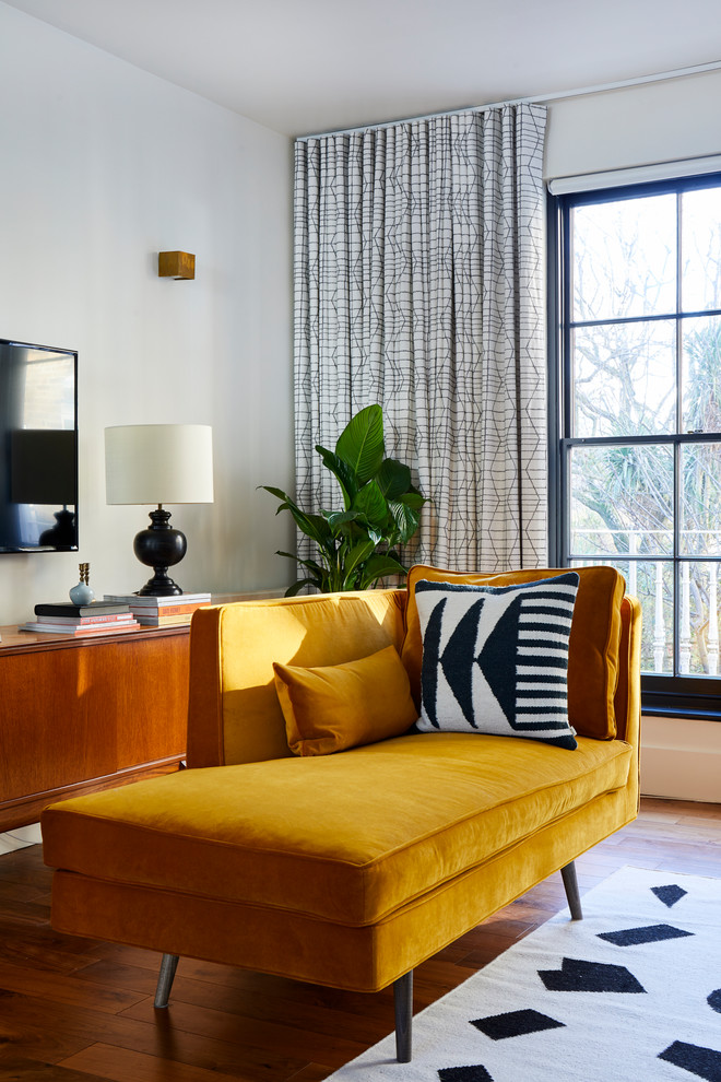 Foto di un soggiorno moderno di medie dimensioni e stile loft con pavimento in laminato, nessun camino, pareti bianche, TV a parete e pavimento marrone