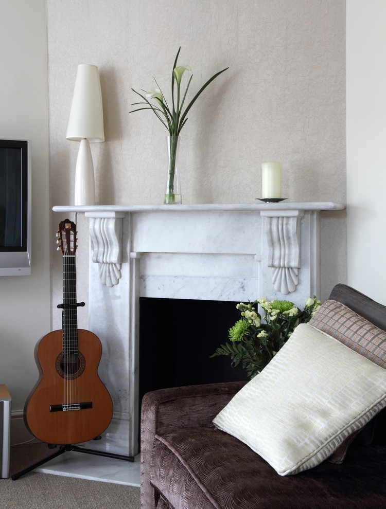 Design ideas for a medium sized contemporary enclosed living room in London with a music area, beige walls, carpet, a standard fireplace, a stone fireplace surround and a wall mounted tv.