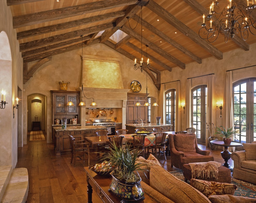 Example of a tuscan open concept medium tone wood floor living room design in San Francisco with brown walls