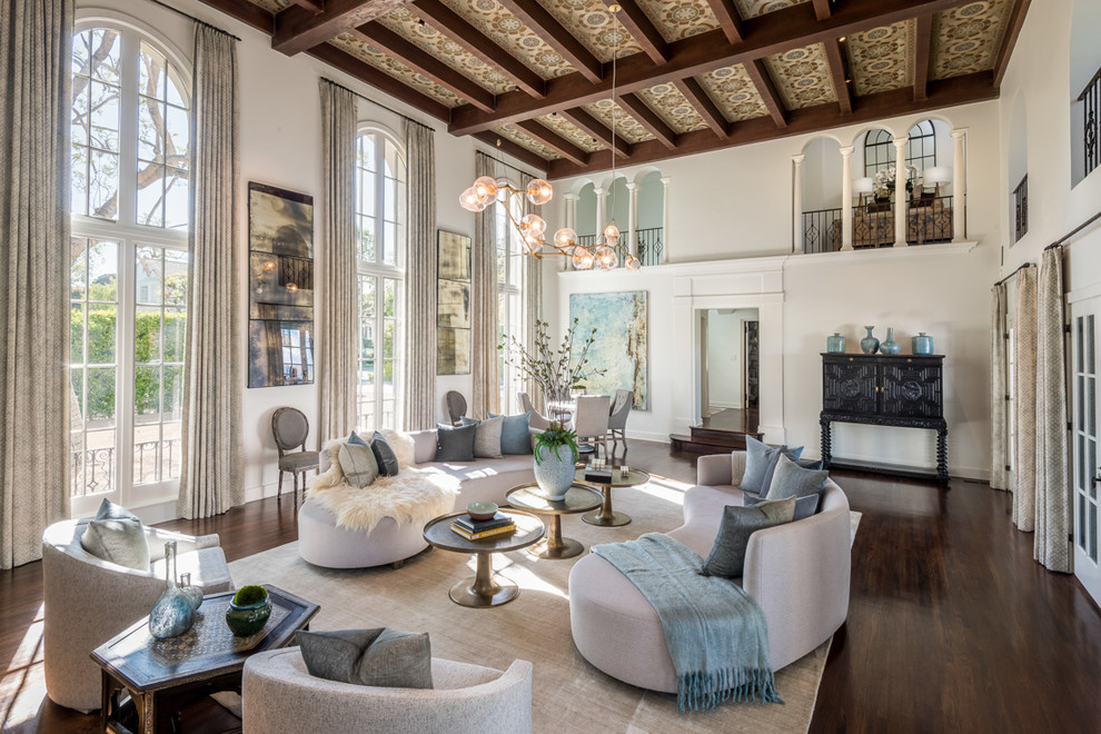 Mediterranean formal enclosed living room in Los Angeles with white walls, dark hardwood flooring and brown floors.