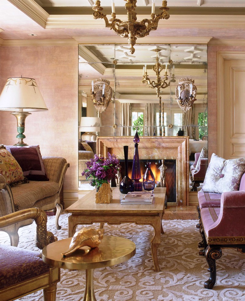 На фото: парадная гостиная комната в классическом стиле с розовыми стенами и стандартным камином без телевизора