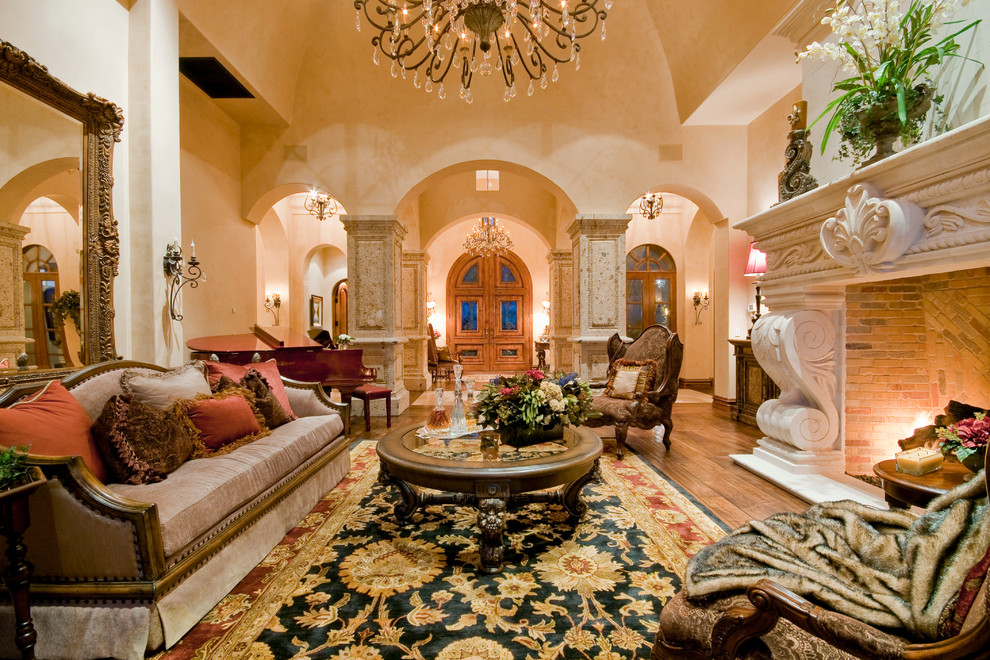Expansive mediterranean formal enclosed living room in Phoenix with beige walls, dark hardwood flooring, a standard fireplace, a stone fireplace surround, no tv and brown floors.