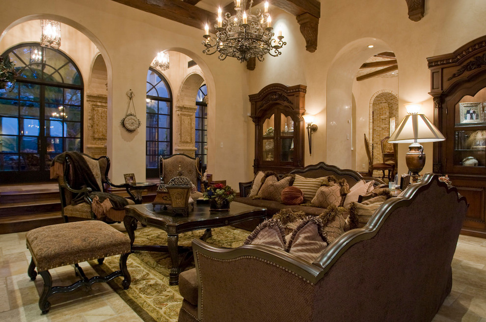 Inspiration for an expansive mediterranean enclosed games room in Phoenix with beige walls, medium hardwood flooring, a standard fireplace, a stone fireplace surround, no tv and a reading nook.