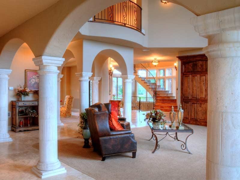 This is an example of a large traditional mezzanine living room in Denver with white walls and marble flooring.