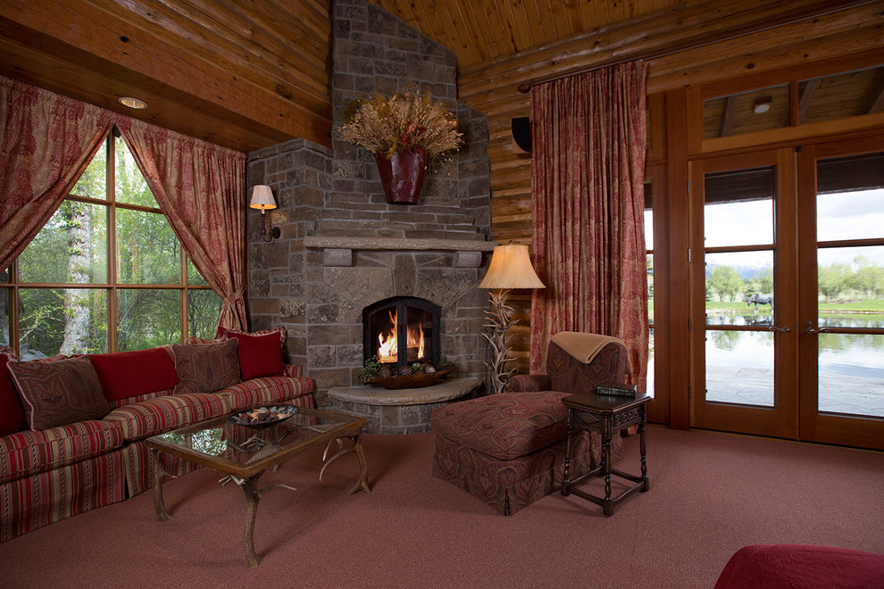Large rustic formal enclosed living room in Jackson with brown walls, carpet, a corner fireplace, a stone fireplace surround, no tv and red floors.