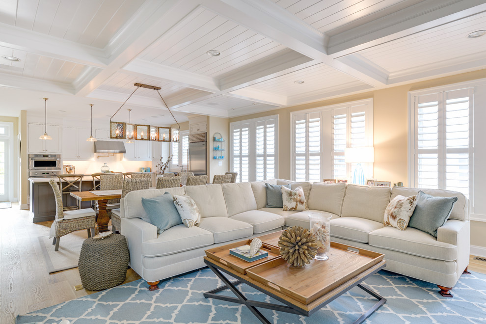 Photo of a nautical open plan living room in Other with beige walls, light hardwood flooring and feature lighting.