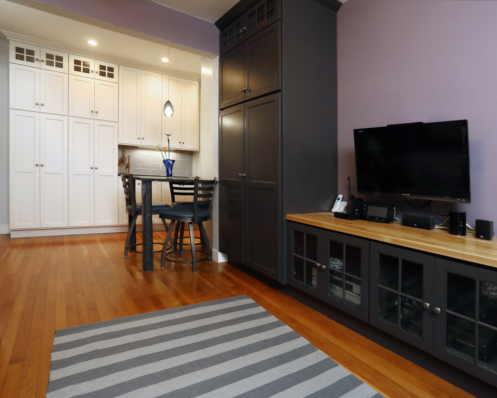 Photo of a small traditional enclosed living room in Boston with purple walls, medium hardwood flooring and a built-in media unit.