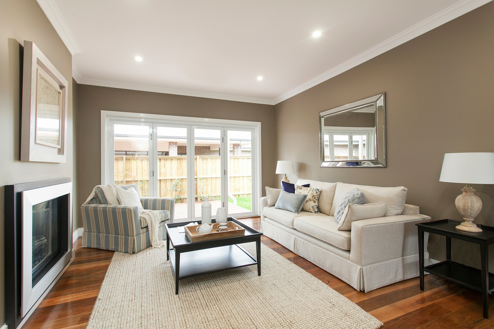 Inspiration for a medium sized country open plan living room in Wollongong with brown walls, medium hardwood flooring, a two-sided fireplace and a metal fireplace surround.