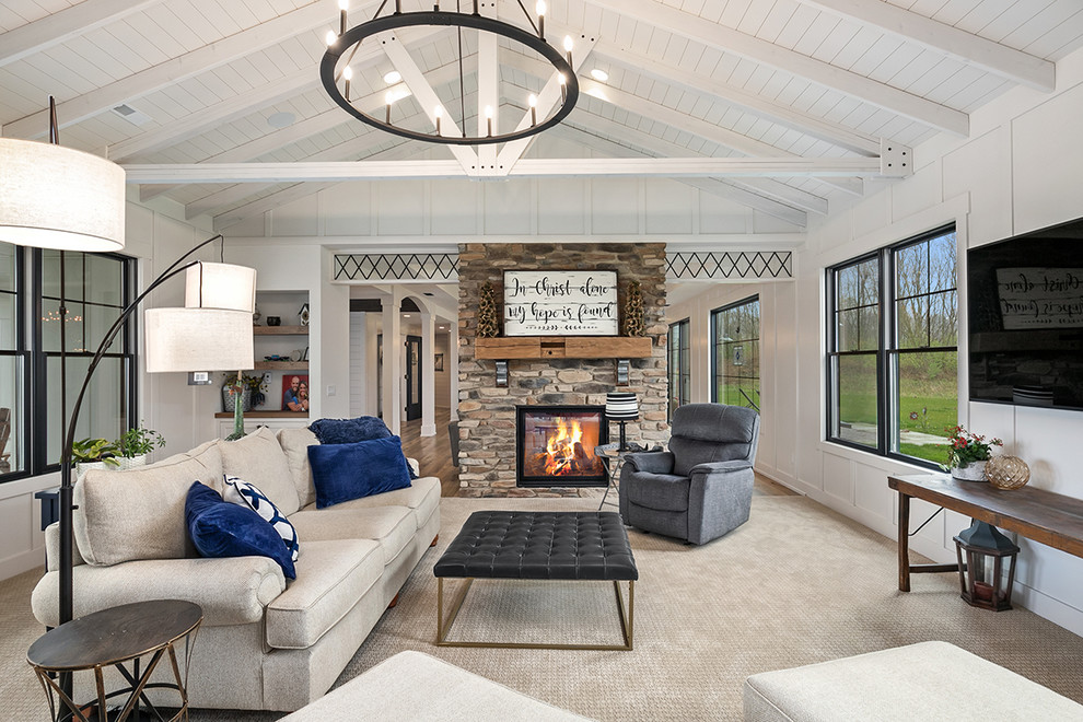 Inspiration for a country enclosed living room in Grand Rapids with white walls, carpet, a two-sided fireplace, a stone fireplace surround, a wall mounted tv and beige floors.